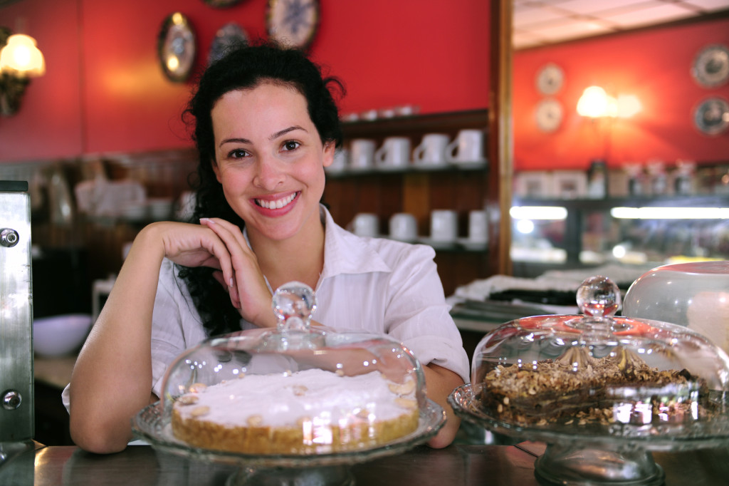 owner of a small business store showing her tasty cakes